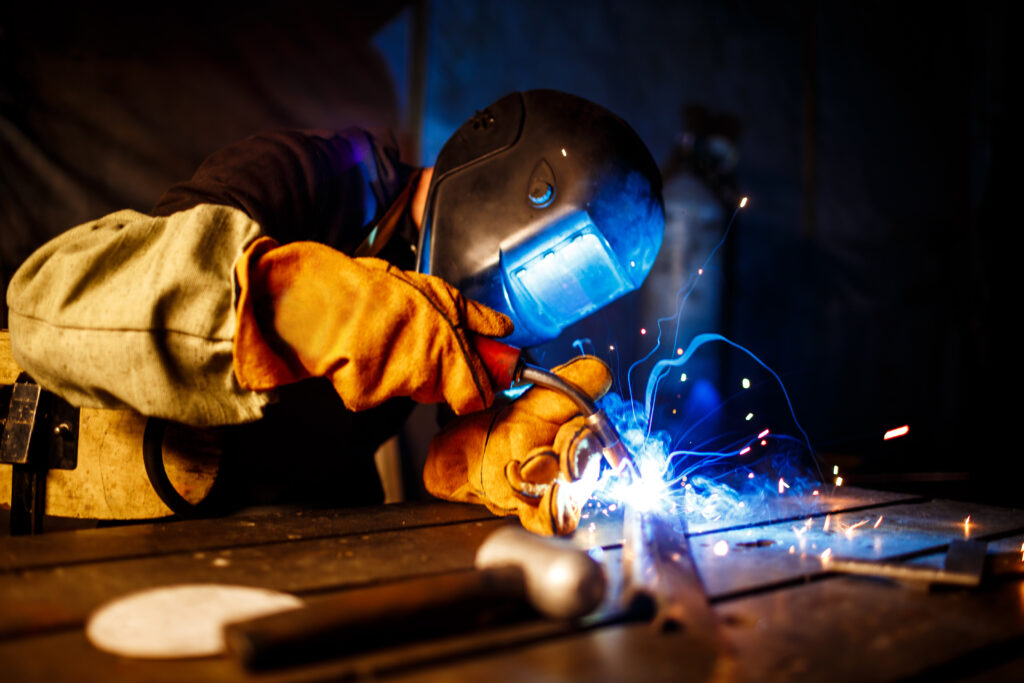 Worker cutting metal with plasma equipment. on plant